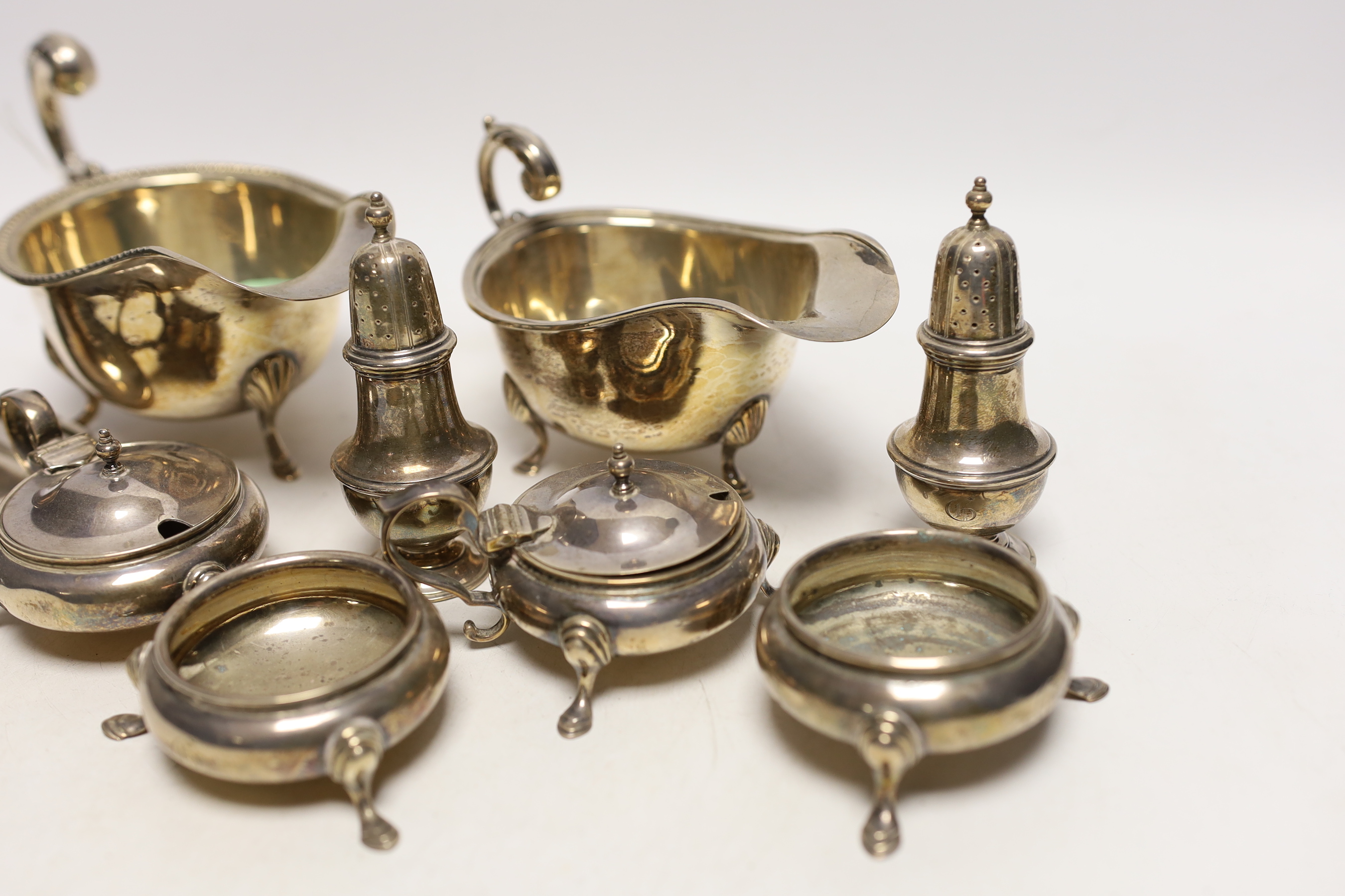 A small selection of silver items to include two sauceboats, a pair of cauldron salts, a further pair of lidded cauldron salts, together with a pair of pots and an inkwell.